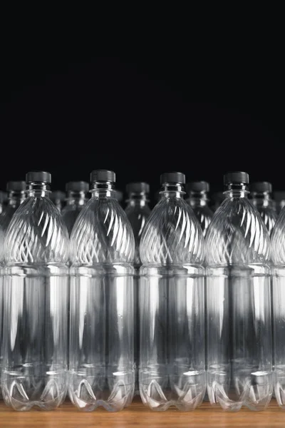 Empty plastic bottles on black background — Stock Photo, Image