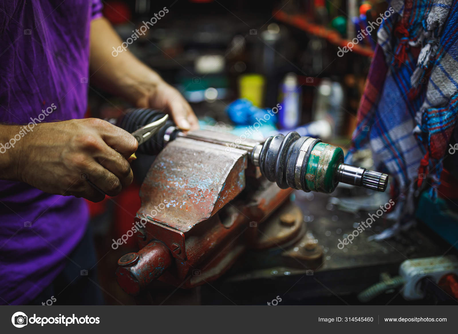ATV constantvelocity CV joint repair by hands in old garage Stock