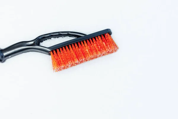 Orange snow brush for car, snowflakes background — Stock Photo, Image