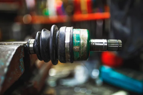 ATV constant-velocity CV joint repair in old garage — Stock Photo, Image