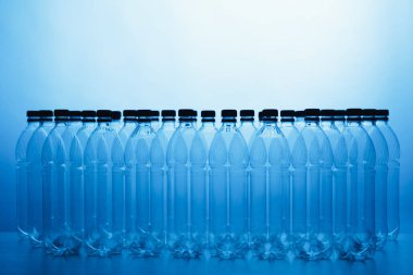 empty plastic bottle silhouettes on blue background clipart