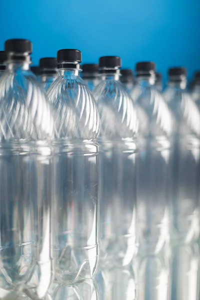 Empty plastic bottles on blue background — Stock Photo, Image