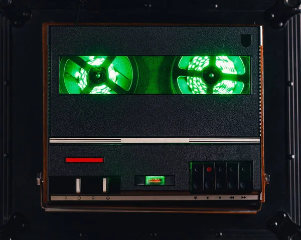 reel to reel audio tape recorder with green led light strip. VU meter with \