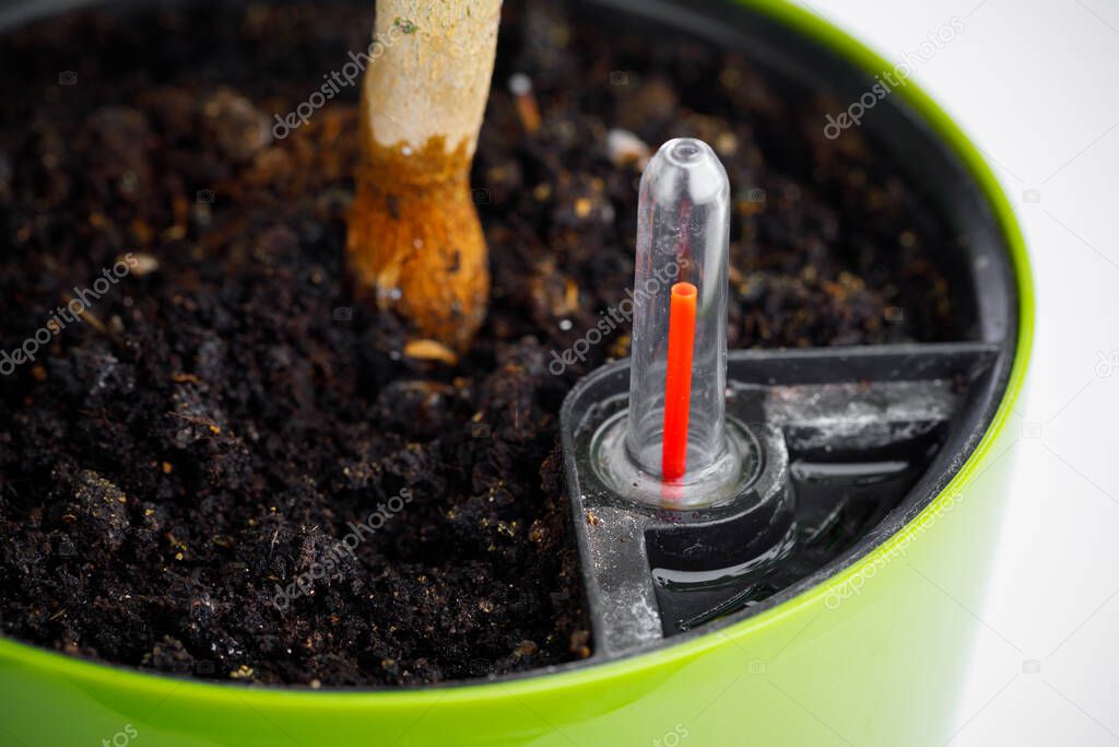 red indicator of self watering planter pot, close-up view