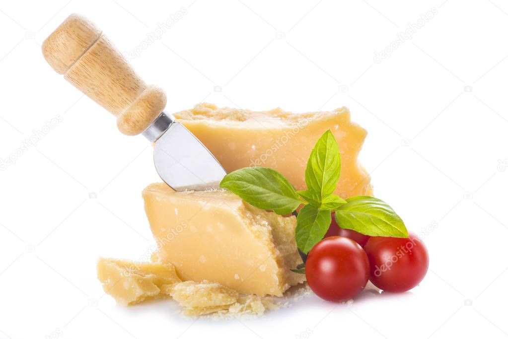 Parmesan cheese or parmigiano reggiano with cherry tomatoes and basil leaves isolated on a white background