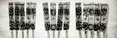 The words SHARE YOUR STORY with old typewriter hammers  with old paper background macro image clipart