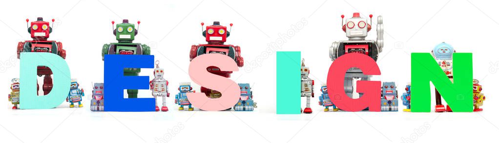 Retro tin robot toys hold up the word  DEDIGN isolated on white