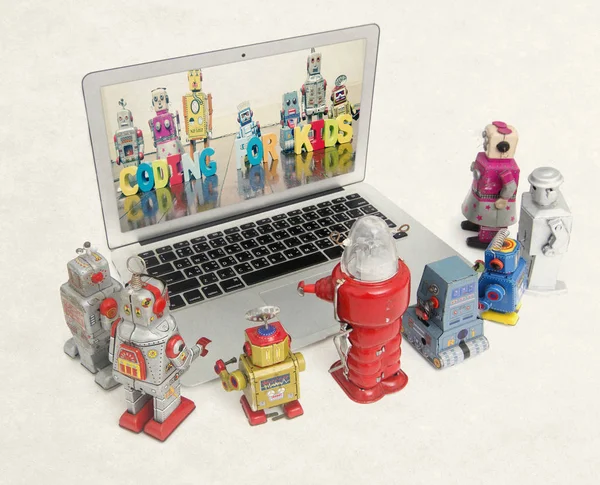 retro robots learn coding  from a laptop  isolated