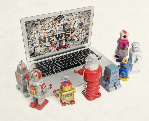 retro robots gather round a laptop to watch the  fake News isolated