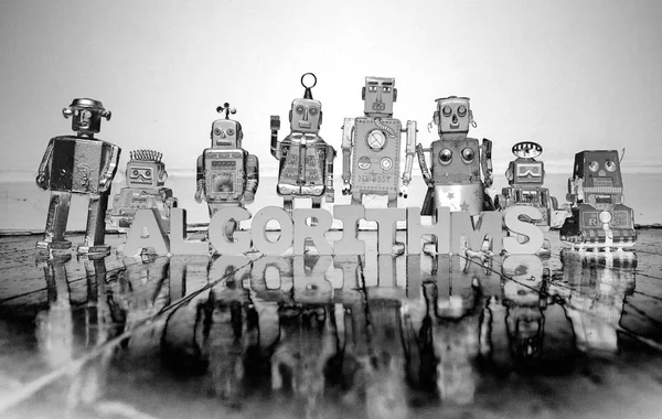 コンピューター プログラミング木製文字と木質系床反射ソラリゼーションによる白黒のレトロなロボット玩具 — ストック写真