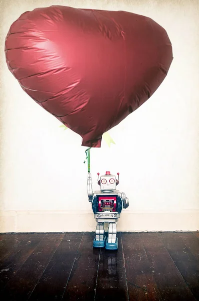 Silver Robot Holding Red Balloon Standing Old Wooden Floor Copy — Stock Photo, Image
