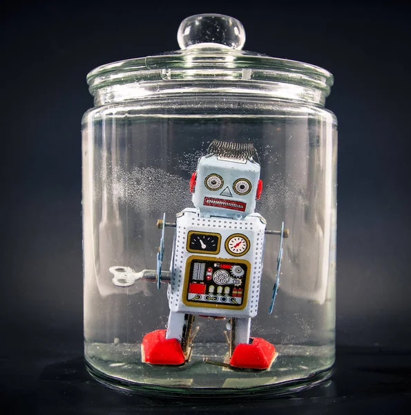 Retro robot toy trapped — Stock Photo, Image