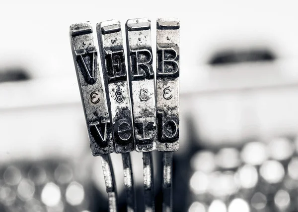 the word  VERB  with old typwriter keys  monochrome