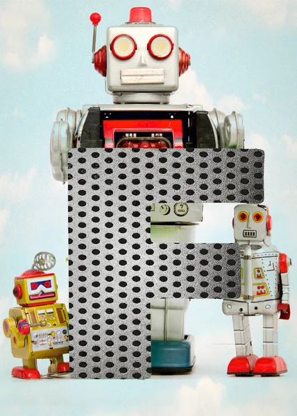 Retro Robot Toys Holding Big Letter — Stock Photo, Image