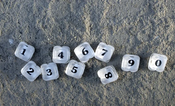 Plastic translucent button numbers of an old calculator on a concrete background — Stock Photo, Image