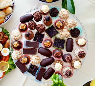 platter of various catering bonbons, table and food decoration top view clipart