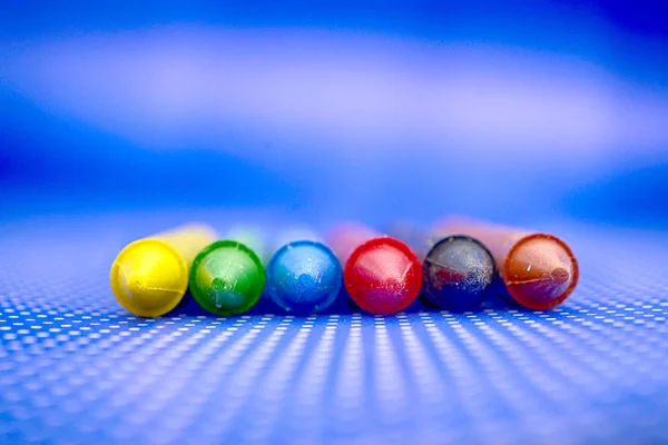 Various colors crayons on a blue background — Stock Photo, Image