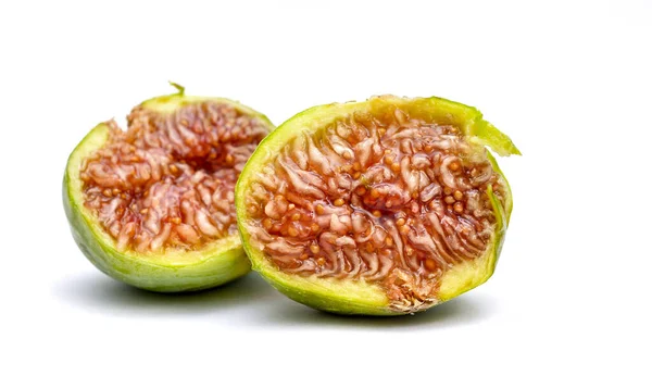 Half fig, macro shot on white background shows the juicy red fruit pulp with the seeds. — Stock Photo, Image
