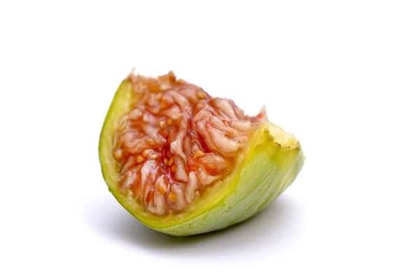 Half fig, macro shot on white background shows the juicy red fruit pulp with the seeds. — Stock Photo, Image