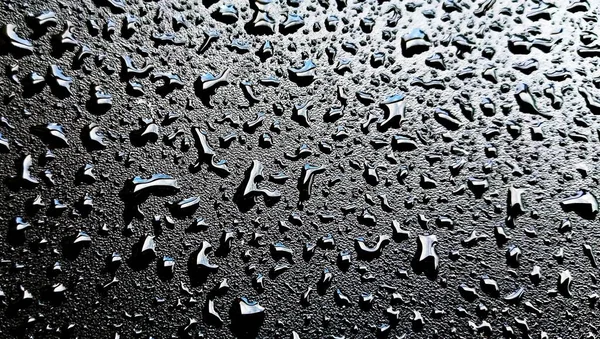 Gotas Lluvia Sobre Imagen Superficial Plástico Negro —  Fotos de Stock