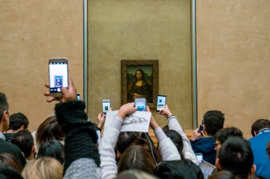 PARIS, FRANCE - FEBRUARY 15, 2018: Visitors take photo of Leonardo DaVinci's 
