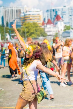 SOCHI , RUSSIA - JULY 07, 2018: Happy young people have fun in colors during festival of colors clipart