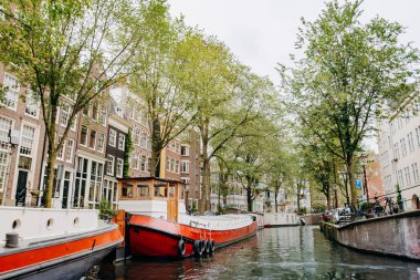 Amsterdam, Hollanda 5 Eylül 2017: Canal Amsterdam, mavna, tarihi başlanmasıyla ve yeşil ağaçlar