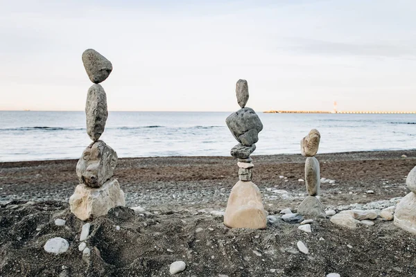 Figures of stones on the beach. Beautiful figures of stones on the background of the sea.