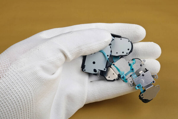 A technician controls the quality of a modern control   system board for digital camera.  Modern technology  macro concept.