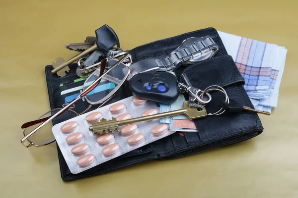 The contents of the pockets of an elderly man