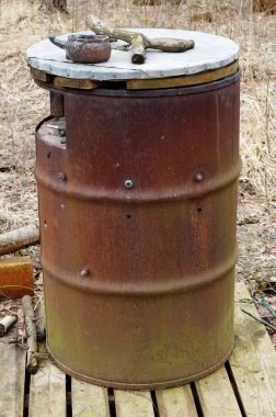 Büyük paslı varil bir kamu küllük olarak ormanda kullanılır.