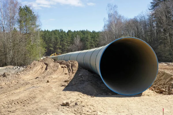 Large  concrete sewer pipe lie on  construction site in the spri — Stock Photo, Image