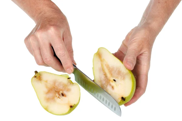 An old senior woman holds a overripe juicy pear  in her hands an — Stock Photo, Image