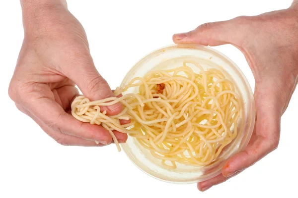 Stary biedny człowiek jeść z rąk długo gotowane makarony spaghetti z pl — Zdjęcie stockowe