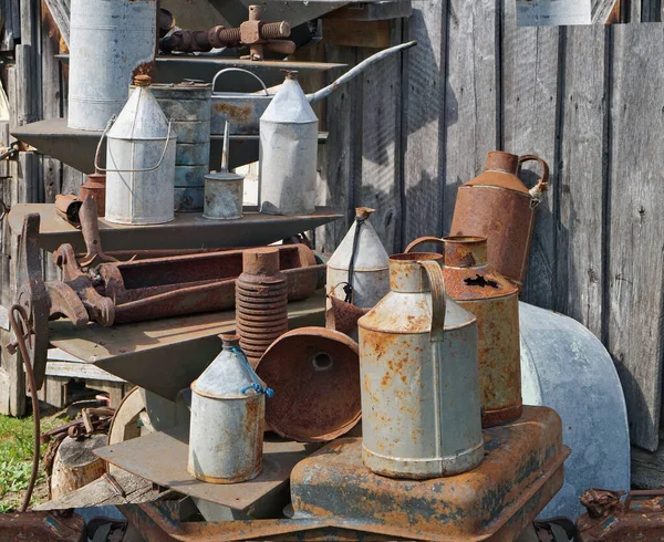 Old rusty vintage metal cans for kerosene and gasoline near the village   shed