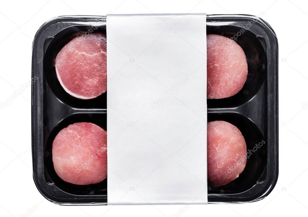 Raw round pork steak slices in plastic tray container with silver label