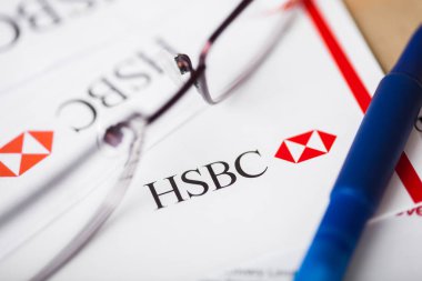 LONDON, UK - AUGUST 18, 2018: HSBC bank statement with logo and glasses. clipart