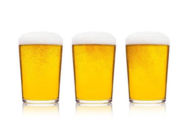 Cold elegant glasses of lager beer with foam and dew isolated on white background