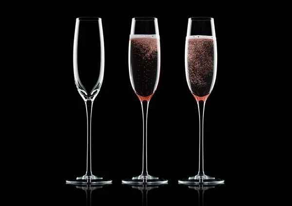 Rose pink champagne glasses with bubbles on black background with reflection