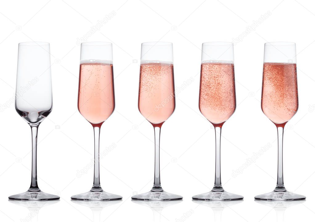 Elegant Rose pink champagne glasses with bubbles  on white background with reflection