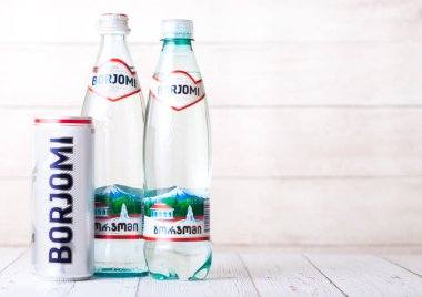 Londra, İngiltere - 03 Eylül 2018: Borjomi köpüklü maden suyu ahşap arka plan üzerinde şişe ve alüminyum olabilir. Borjomi Gürcistan tarihi.