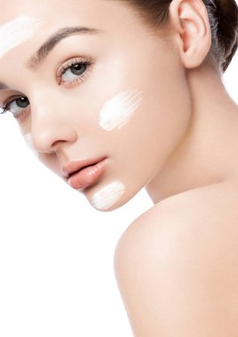 Yüz kremi sürmüş güzel bir kız. Beyaz arka planda doğal makyaj resmi.