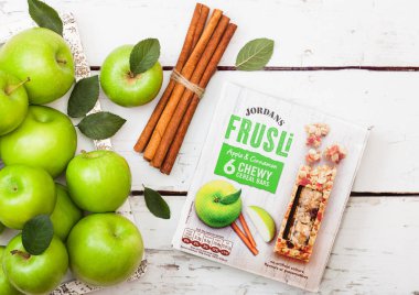 LONDON, UK - SEPTEMBER 15, 2018: Box of Jordans Frusli with apple and cinnamon taste with fresh apples. clipart