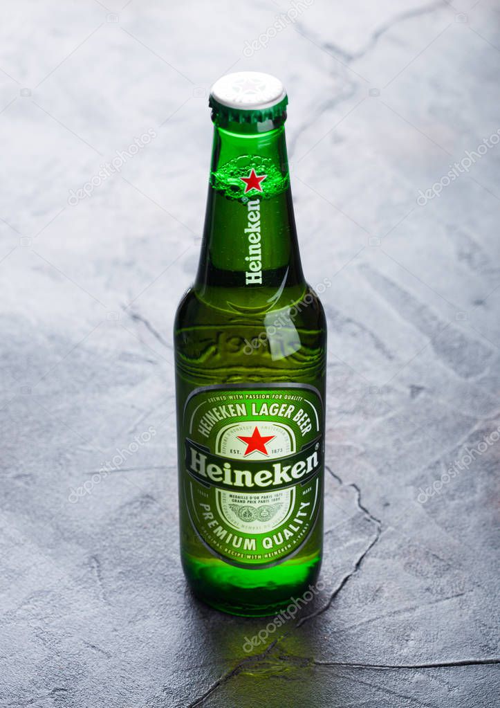 LONDON, UK - OCTOBER 03, 2018: Glass bottle of Heineken lager beer on stone background