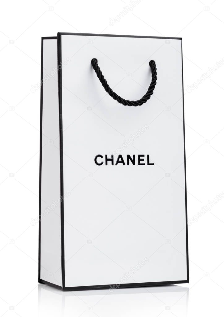 LONDON, UK - JANUARY 15, 2019: Paper Chanel shopping bag, white with black stripes and letters on white