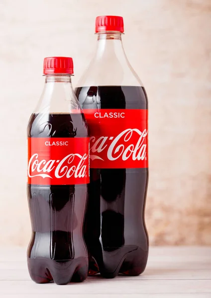 LONDON, UK - AUGUST 03, 2018: Plastic bottles of Original Coca Cola soft drink on wooden background. Most popular drink in the world — Stock Photo, Image