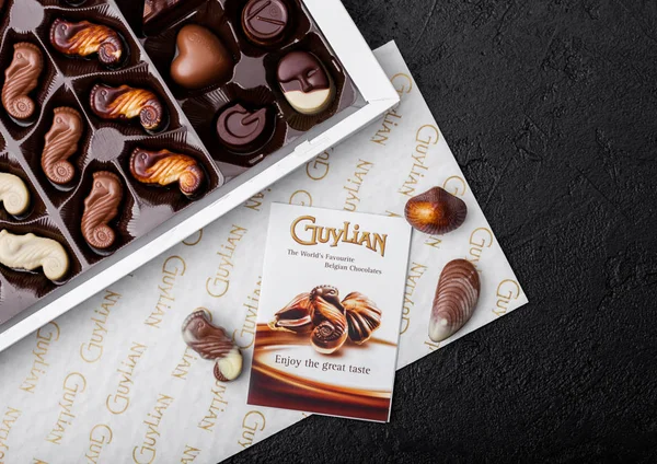 LONDON, UK - APRIL 15, 2019: Box of Guylian The World 's Favourite Belgian Chocolates on black stone background . — Stok Foto