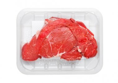 Fresh raw organic slice of braising steak fillet in plastic tray on white background. clipart