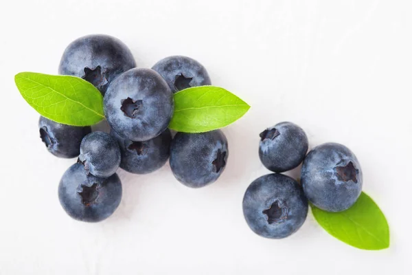 Fresh raw organic blueberries with leaf on white background. Macro close up Stock Image