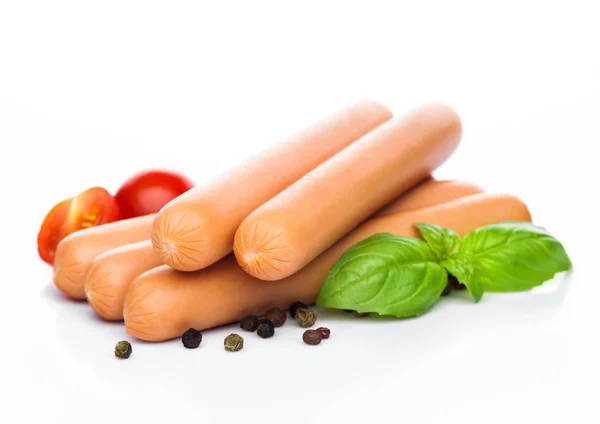 Classic boiled meat pork sausages with pepper and basil and cherry tomatoes on white background. — Stock Photo, Image